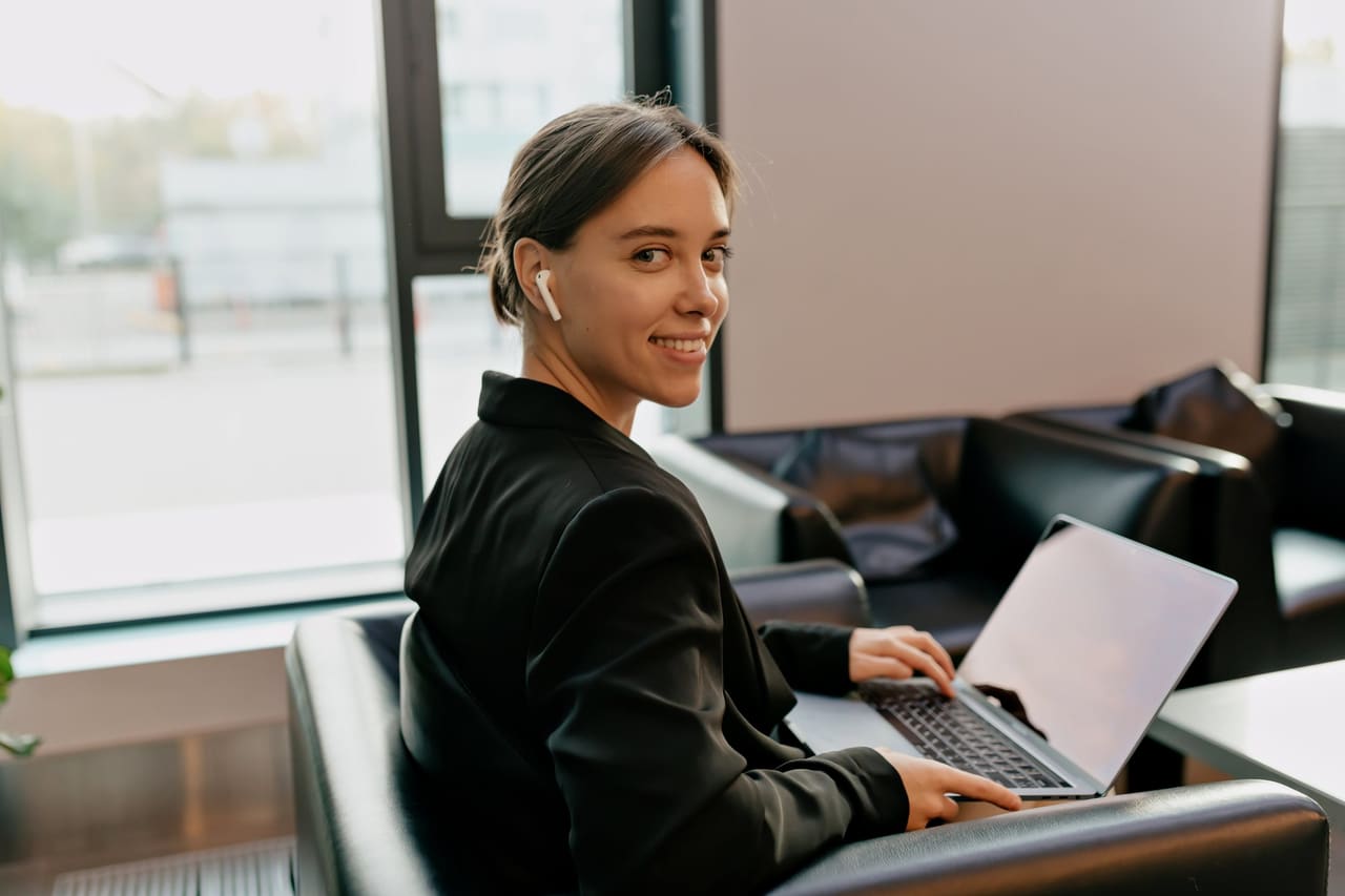 A coordinator at her laptop in a bright office